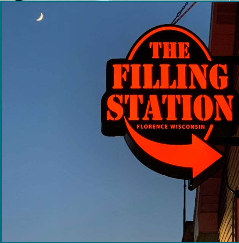 The Filling Station orange neon sign at dusk in Florence, Wisconsin